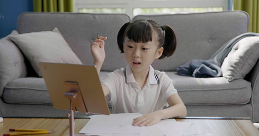 Little girl taking an online class