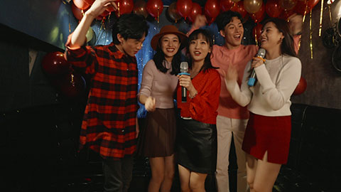 Happy young Chinese friends singing karaoke in nightclub,4K
