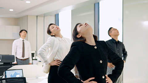 Chinese business people exercising in office