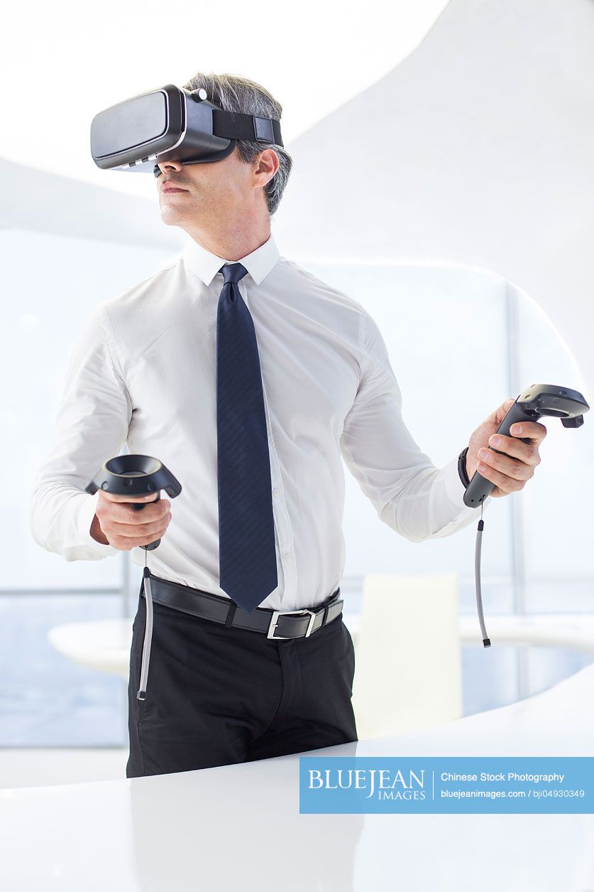 Businessman wearing VR glasses in office