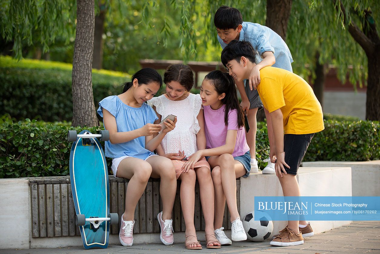 Teenagers using smartphone outdoors