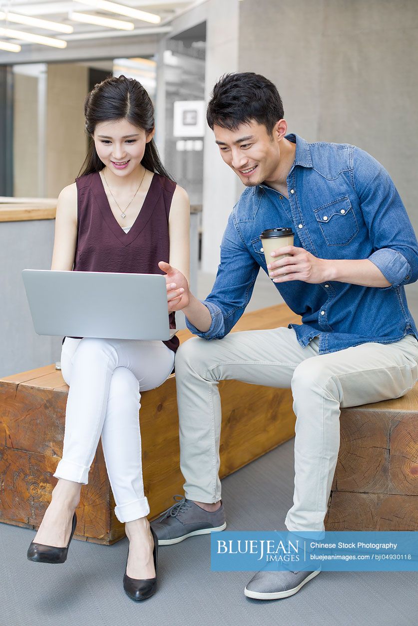 Chinese business people working with laptop in office