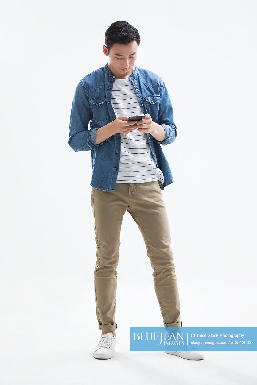 Young Chinese man using smart phone