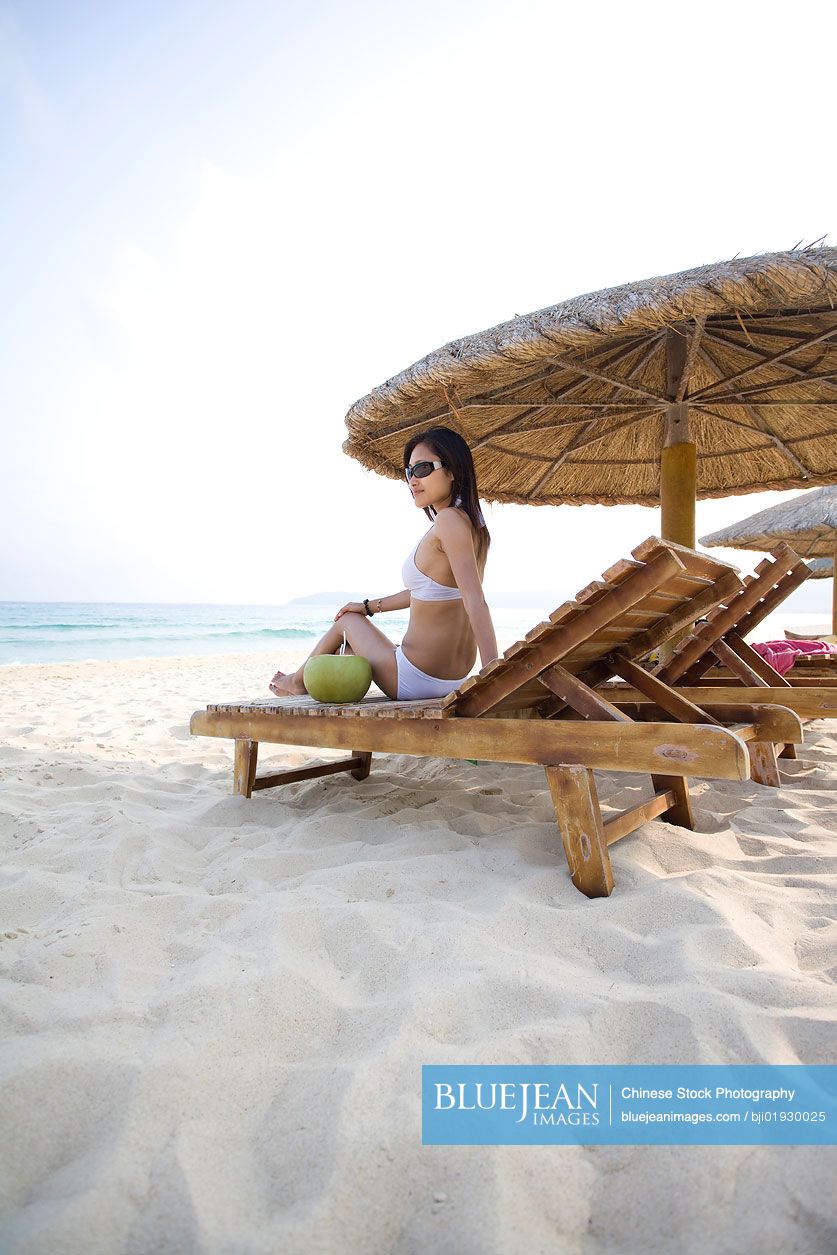 Young Chinese woman relaxing on the beach