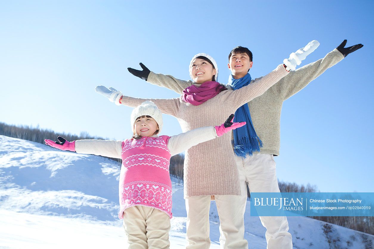 Chinese family having fun in snow