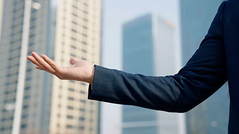 Confident Chinese businessman standing outdoors