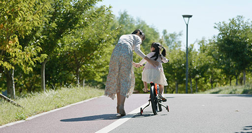 Chinese mother teaching daughter to ride bike,4K