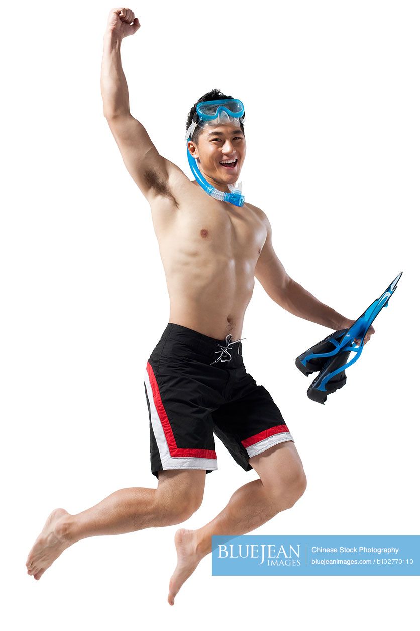Chinese man with swimming gear jumping in happiness
