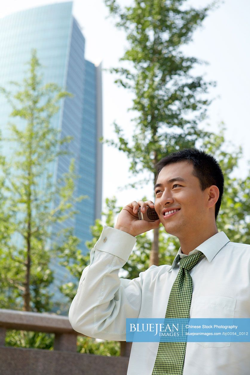 Chinese businessman talking on cell phone