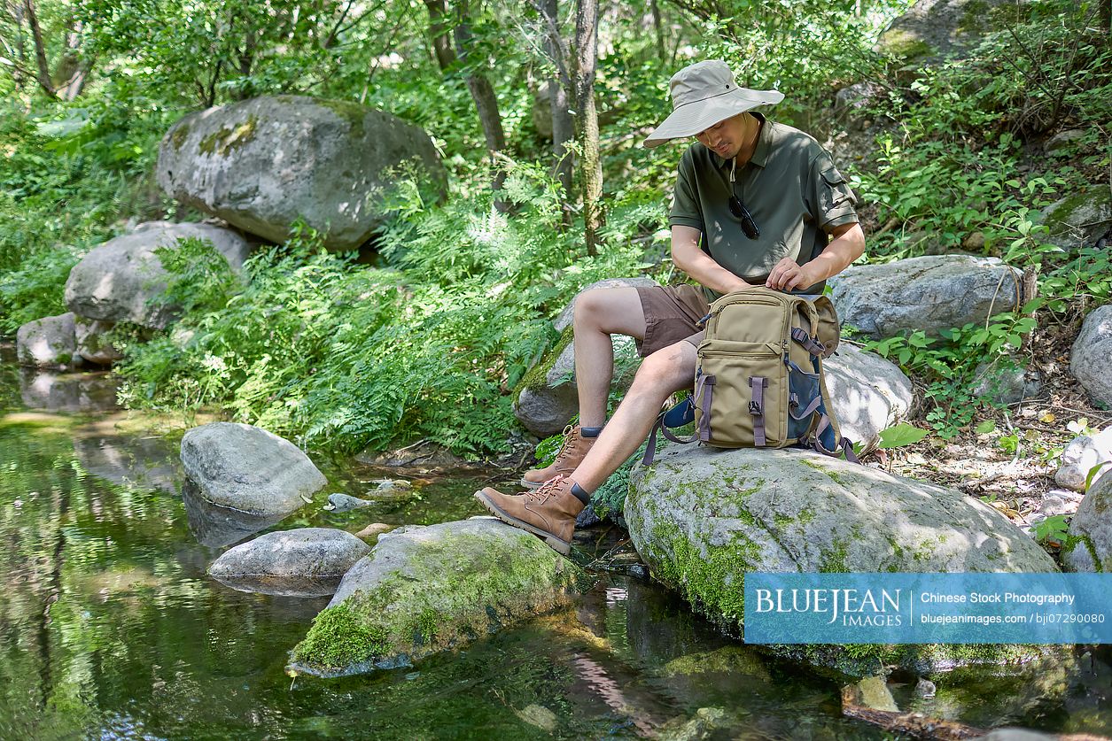 Man with his hiking bag ventures into the wilderness