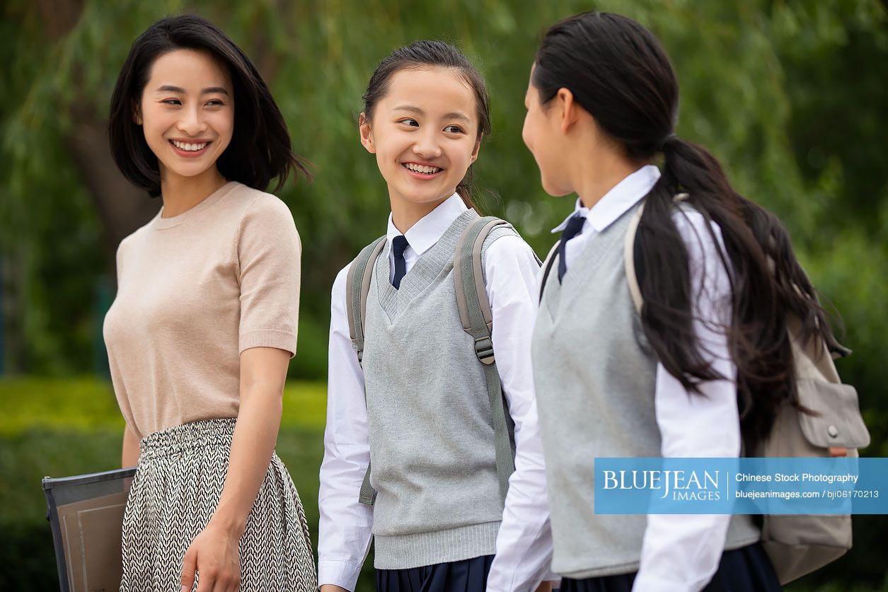 Chinese teacher talking with student on campus