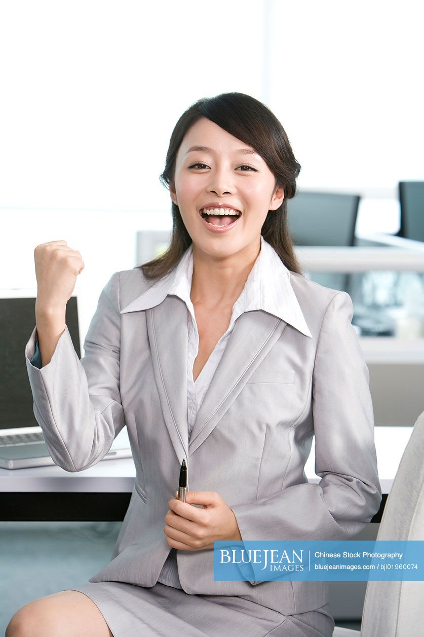 Chinese office worker at her desk