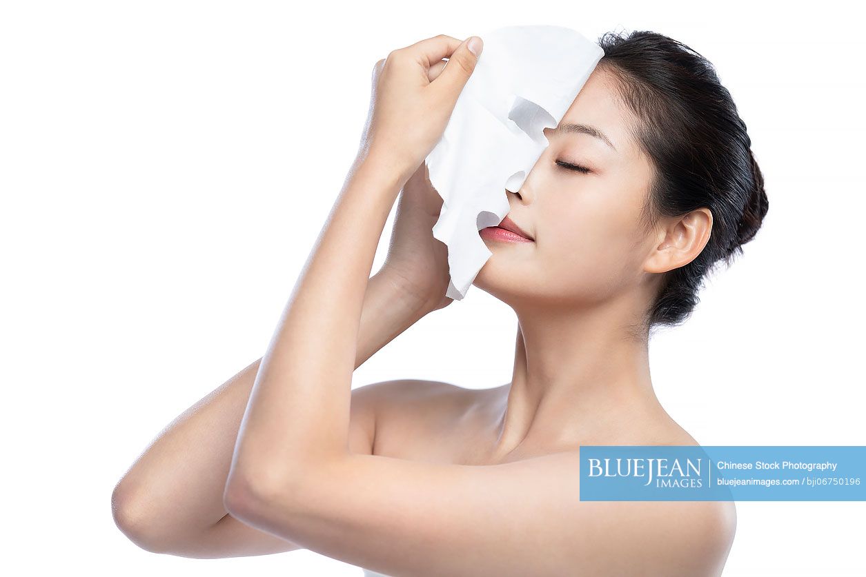 Beautiful young Chinese woman with facial mask