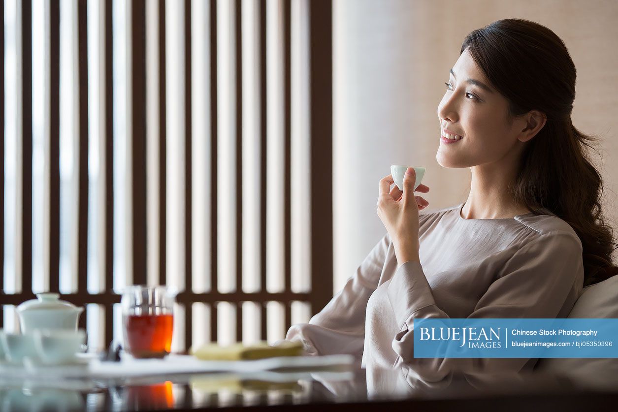 Young Chinese woman drinking tea