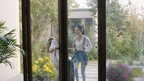 Happy young Chinese couple entering hotel room with suitcase,4K