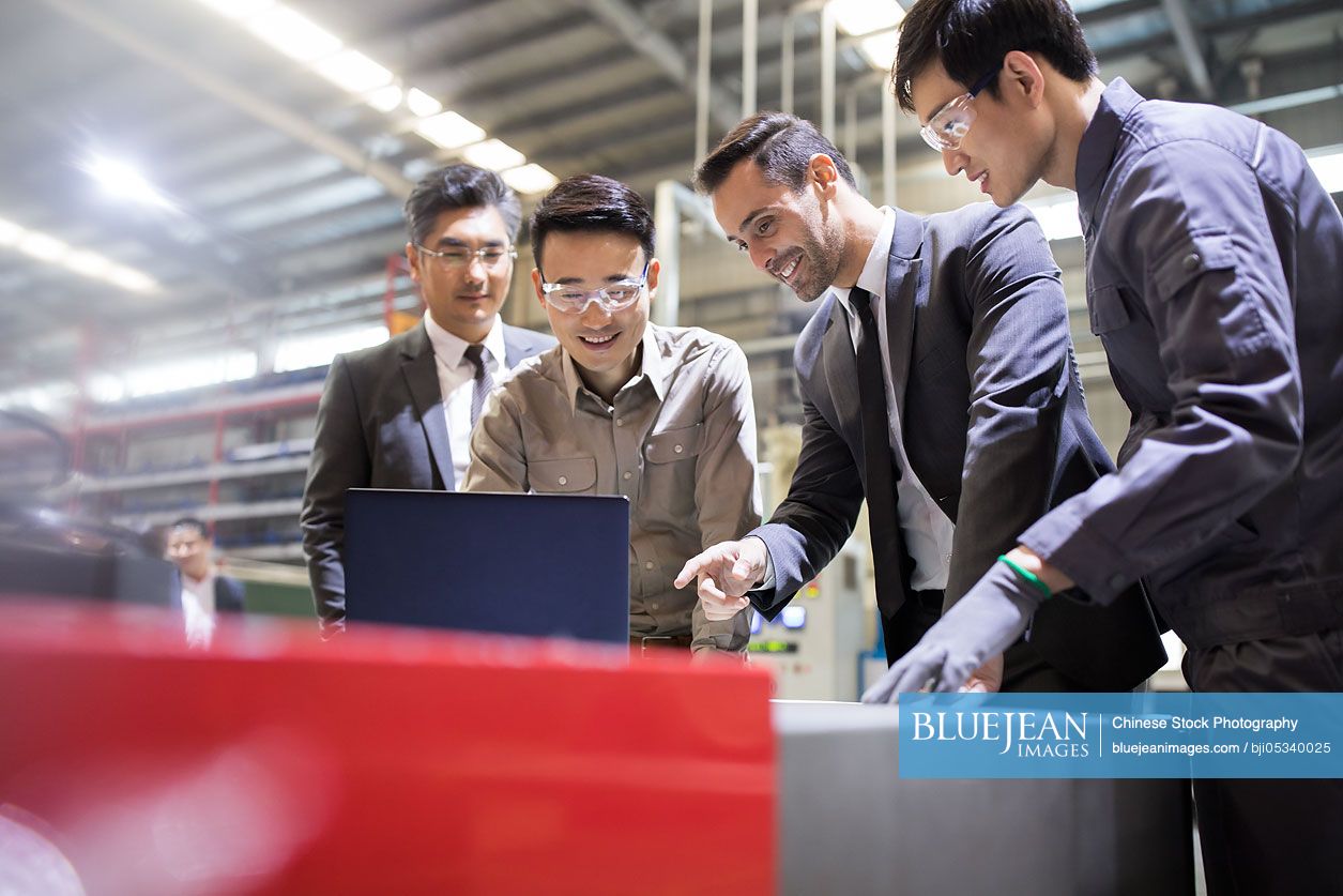 Businessmen and engineers talking in the factory