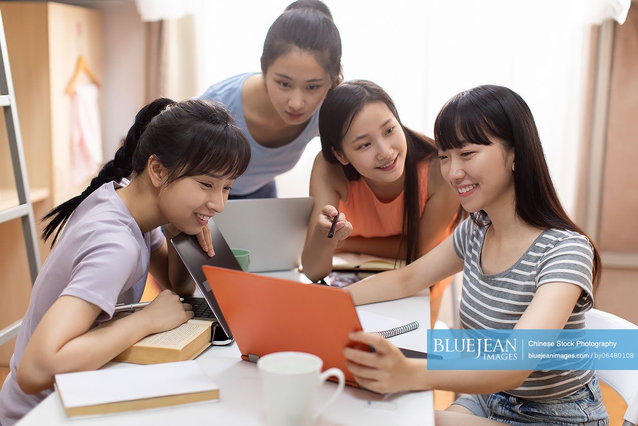 Young Chinese university students learning in dormitory