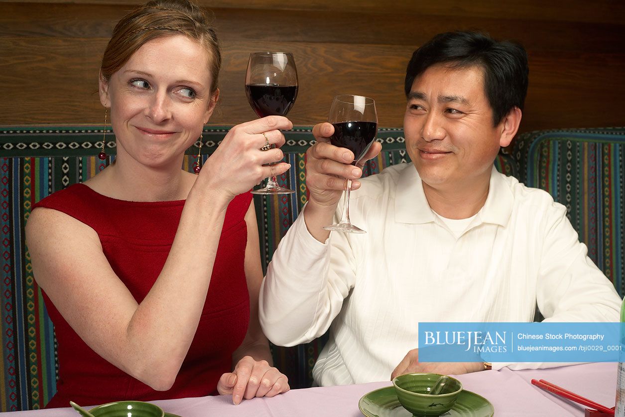Couple Toasting With Wine Glasses