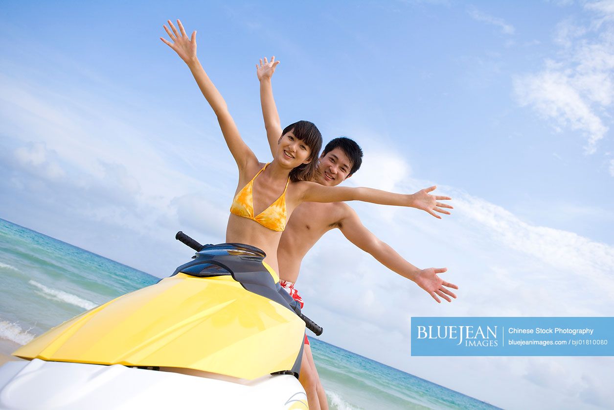 Young Chinese couple on a jet ski