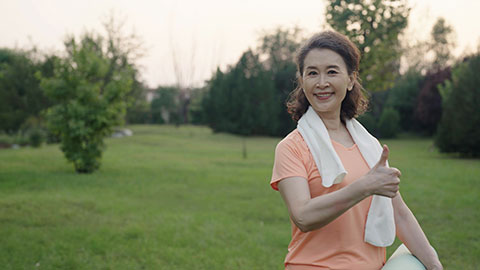 Happy senior Chinese woman exercising in park,4K