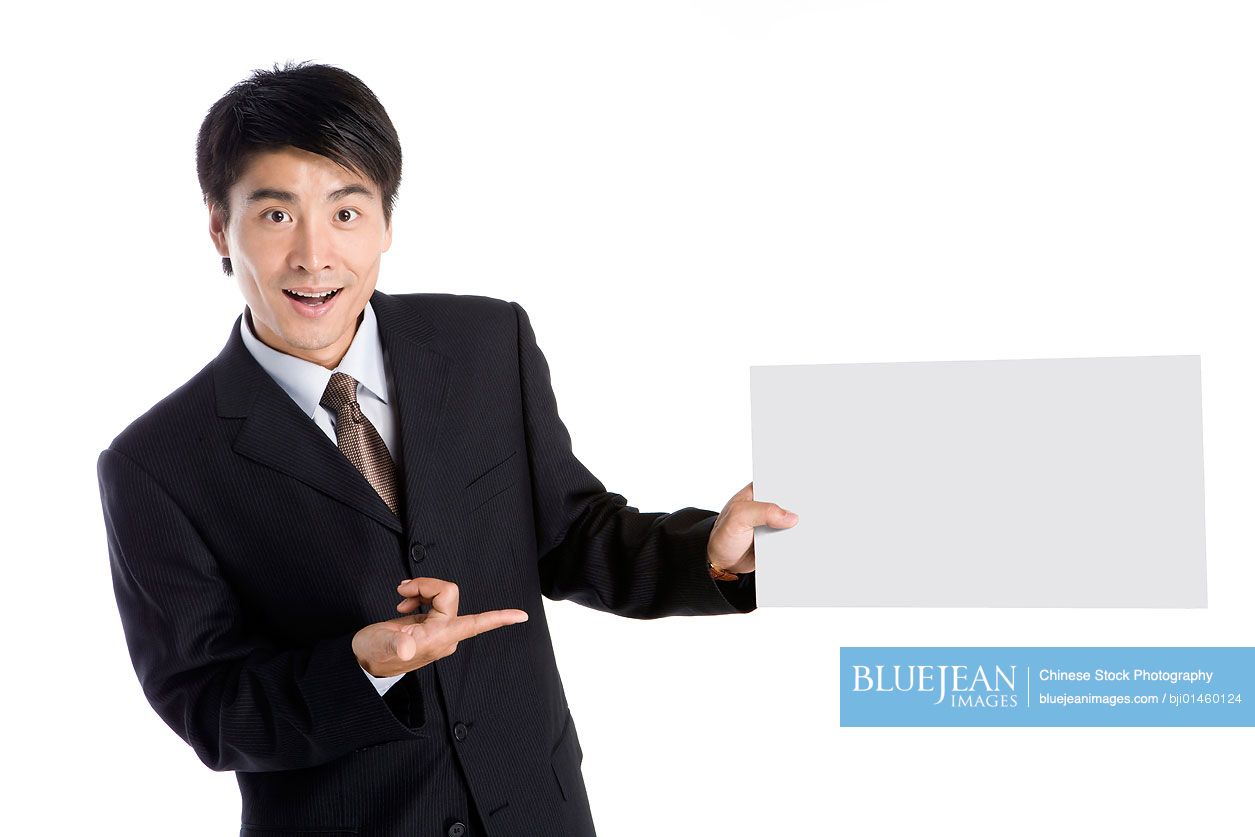 Young Chinese businessman holding a white board