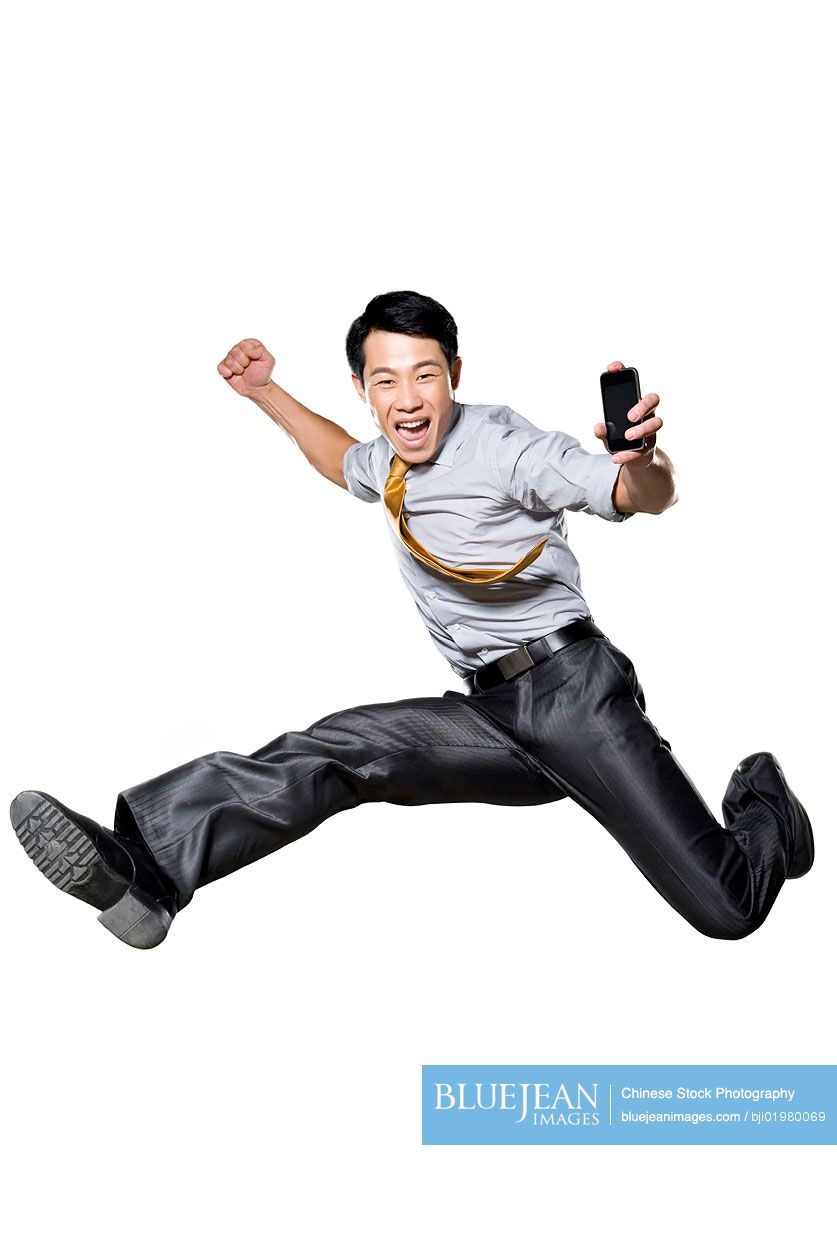 Chinese businessman jumping in the air in celebration