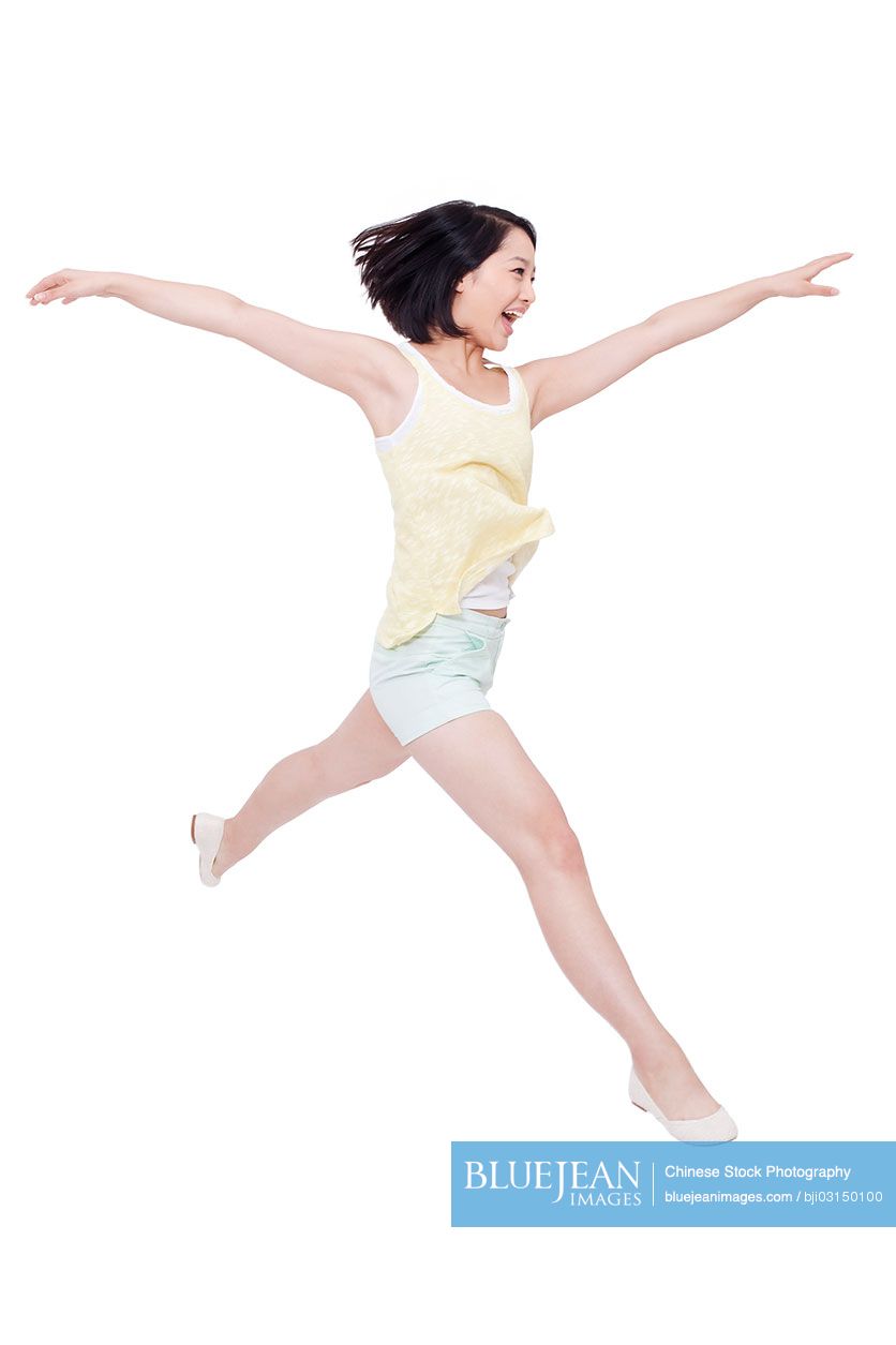 Happy young Chinese woman jumping