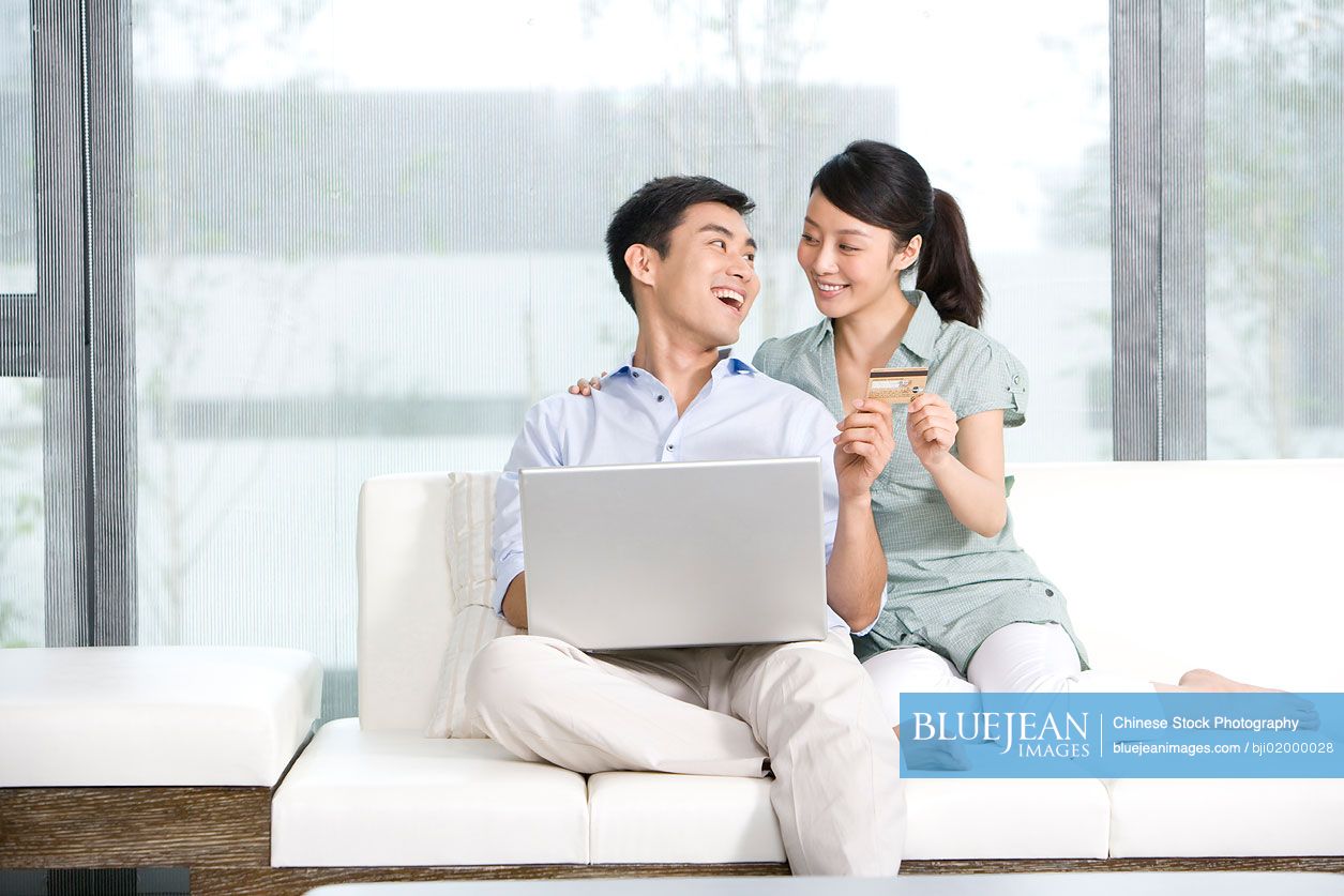 Portrait of  Chinese couple online shopping from home