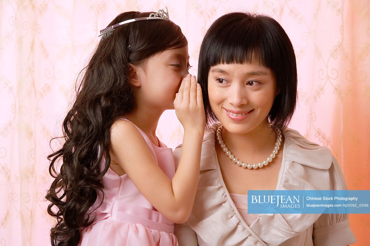Chinese mother and daughter sharing secrets
