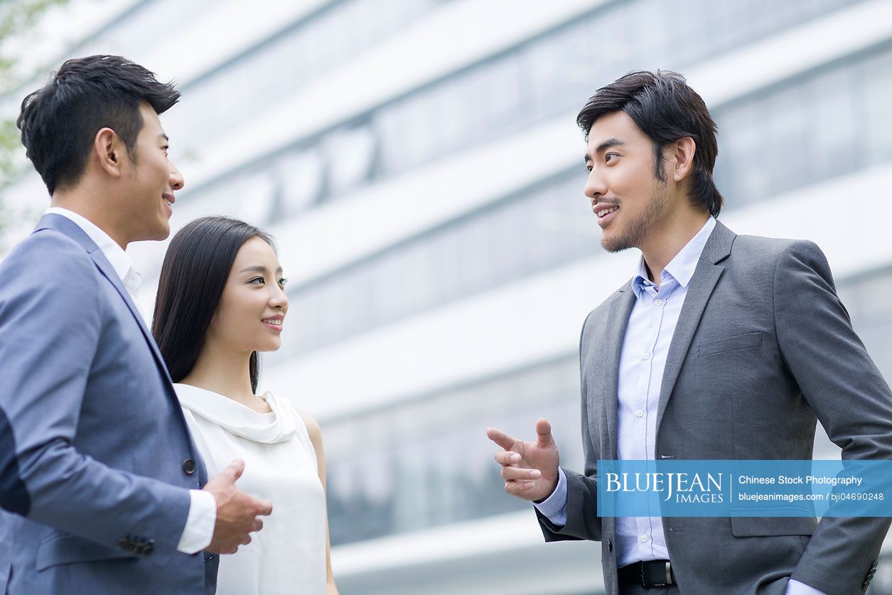Chinese businesspeople talking outdoors