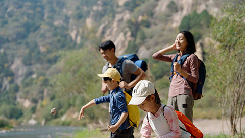 Happy young Chinese family having fun outdoors