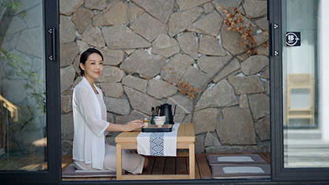 Elegant young Chinese woman drinking tea in tea room,4K