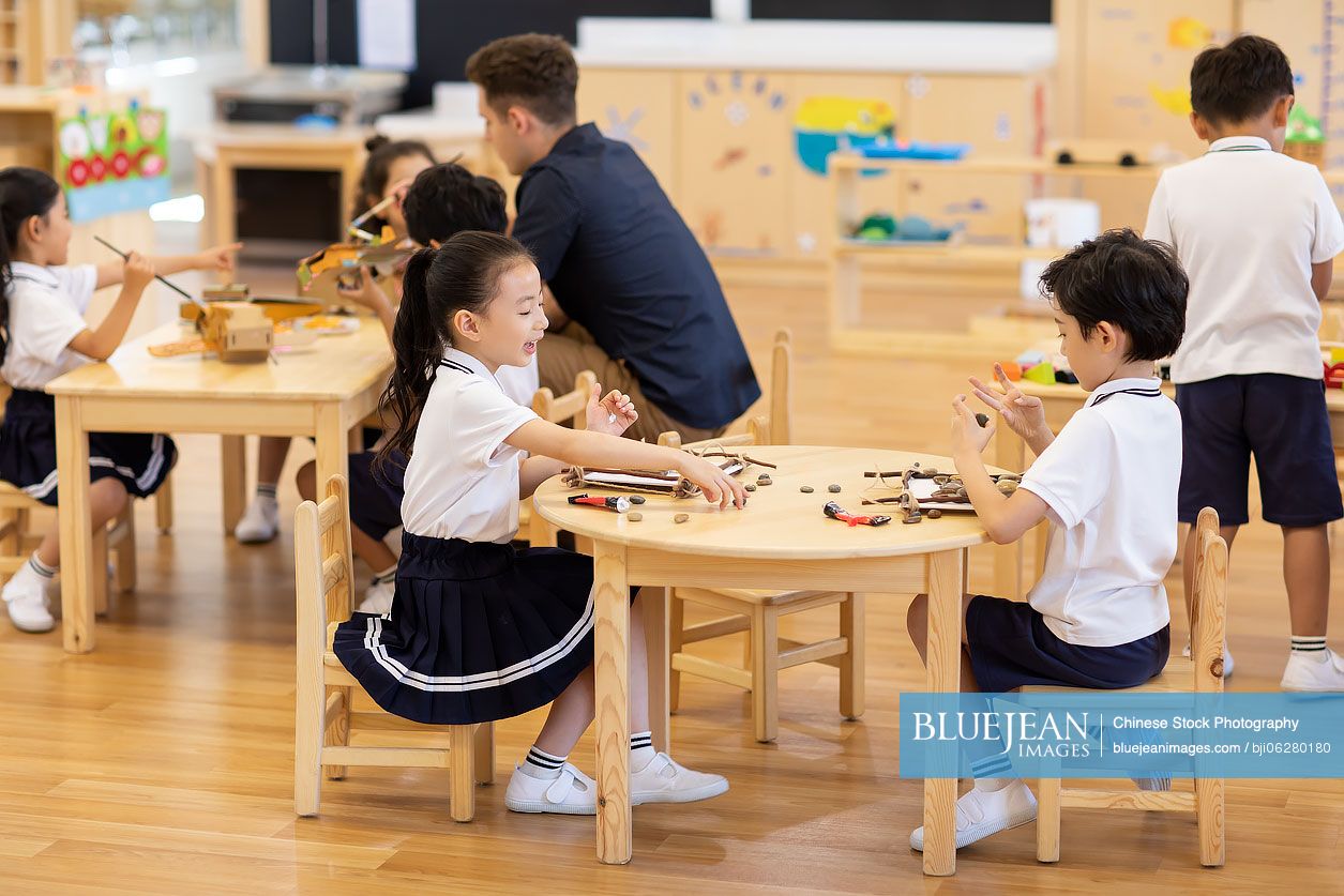 Foreign teacher teaching art class in classroom