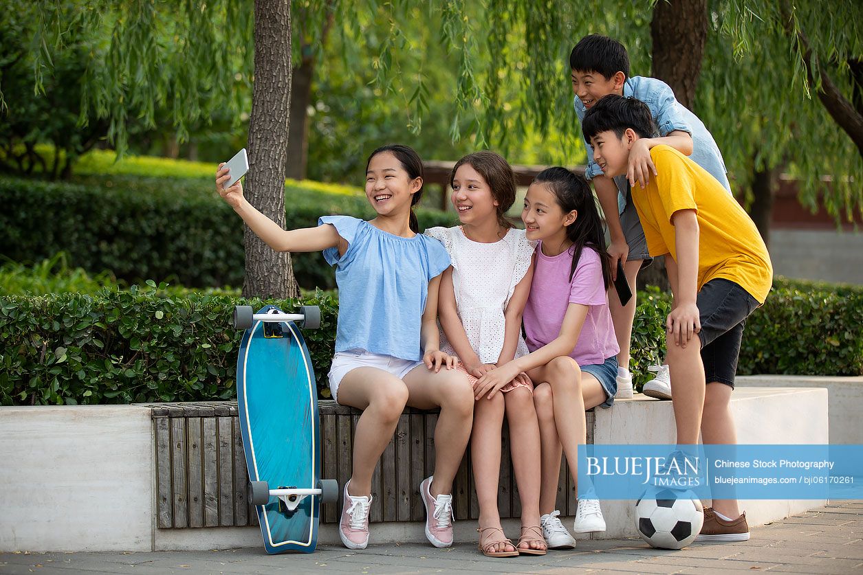 Teenagers taking selfie with smartphone