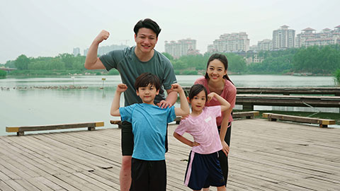 A young family works out in the park, staying active and healthy