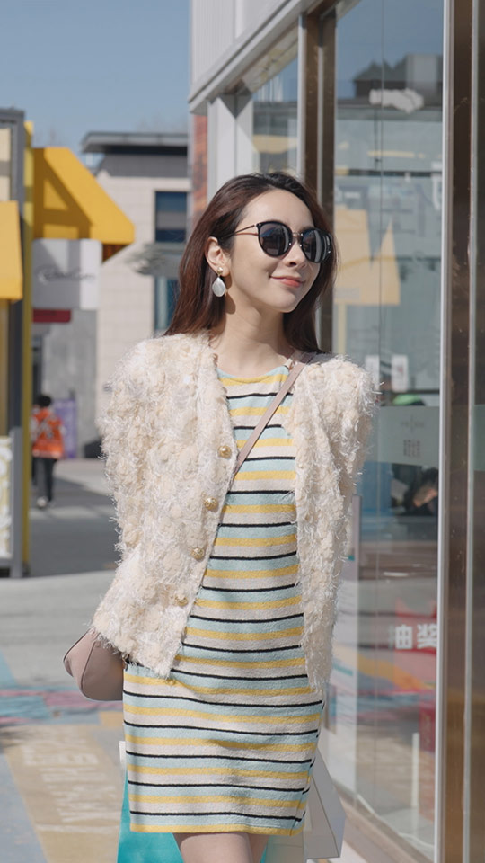 Cheerful young Chinese woman walking with shopping bags,HD