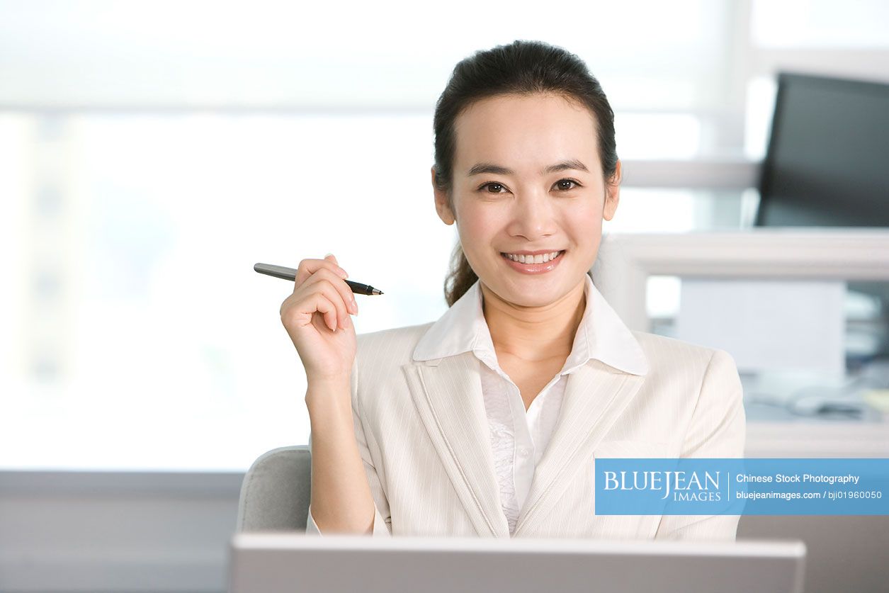 Chinese office worker at her desk