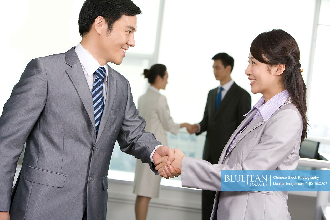 Chinese business people shaking hands