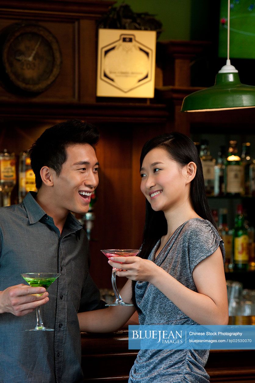 Chinese couple enjoying cocktails together