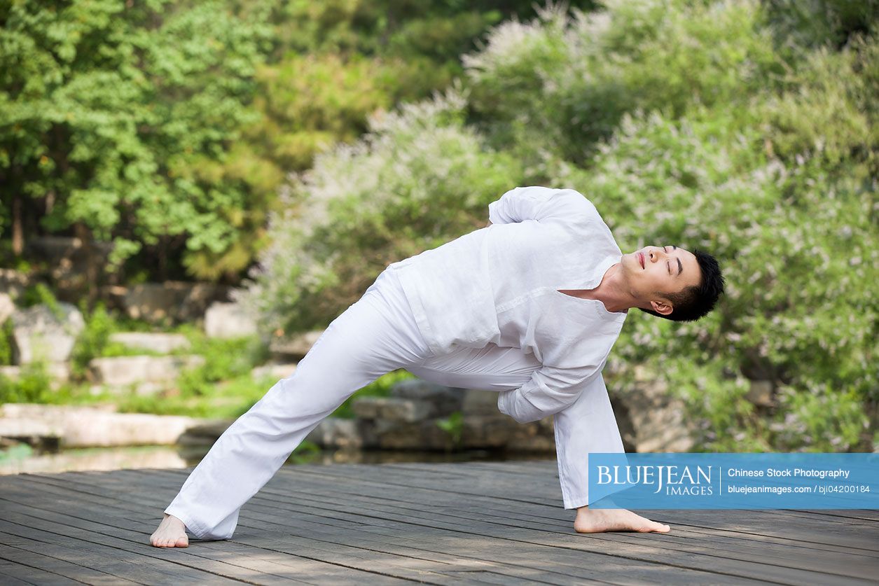 Young Chinese man practicing yoga