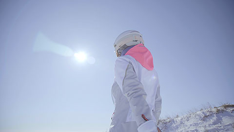 Young Chinese woman walking with snowboard on the snow,4K
