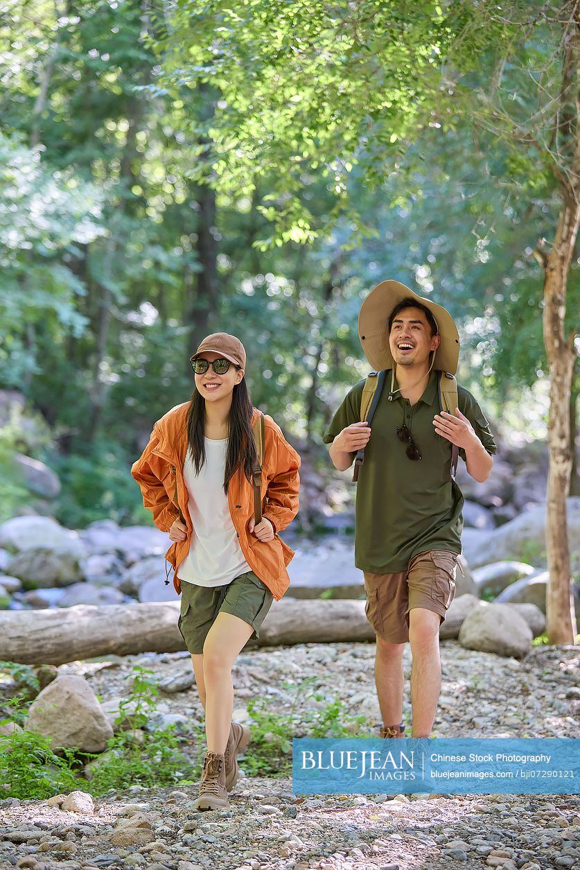 Happy couple hiking through the serene beauty of nature