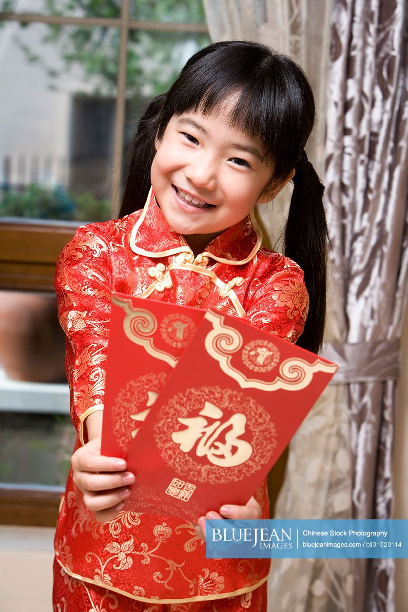 Portrait of Chinese boy holding red envelope
