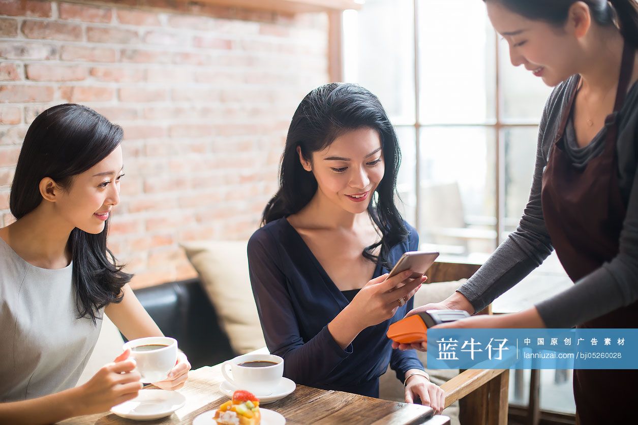 闺蜜俩在咖啡馆用手机结账