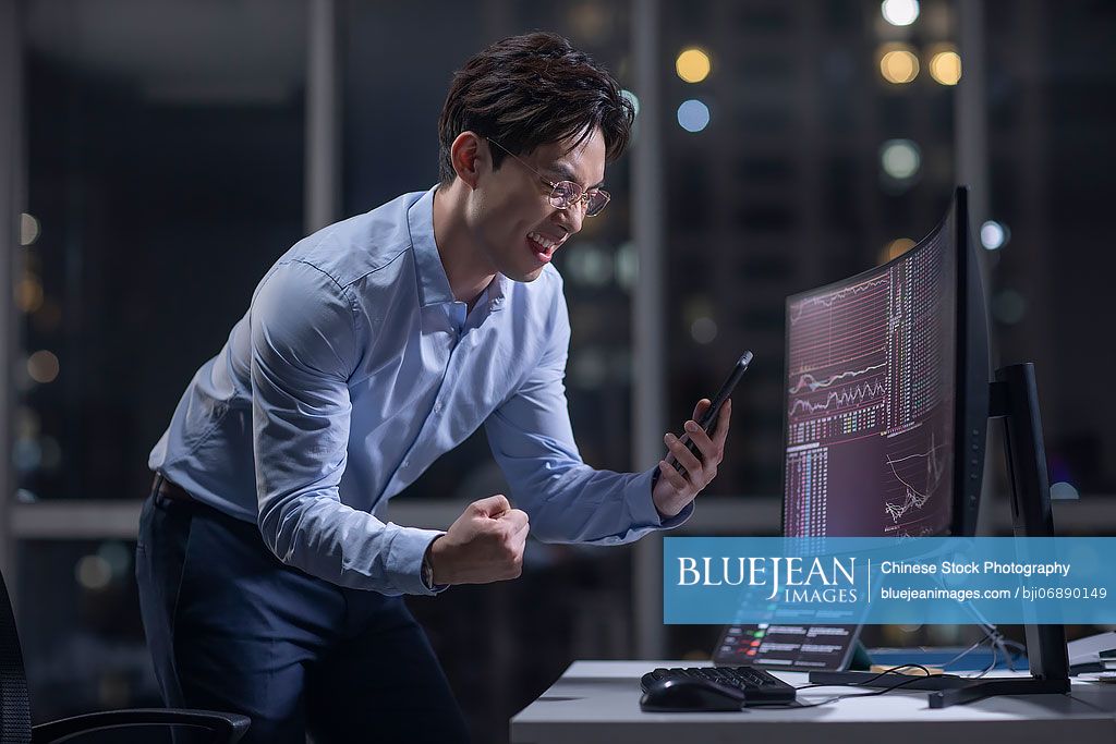 Chinese businessman working in office at night