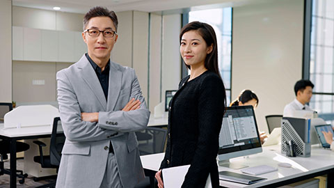 Confident Chinese business people standing in office