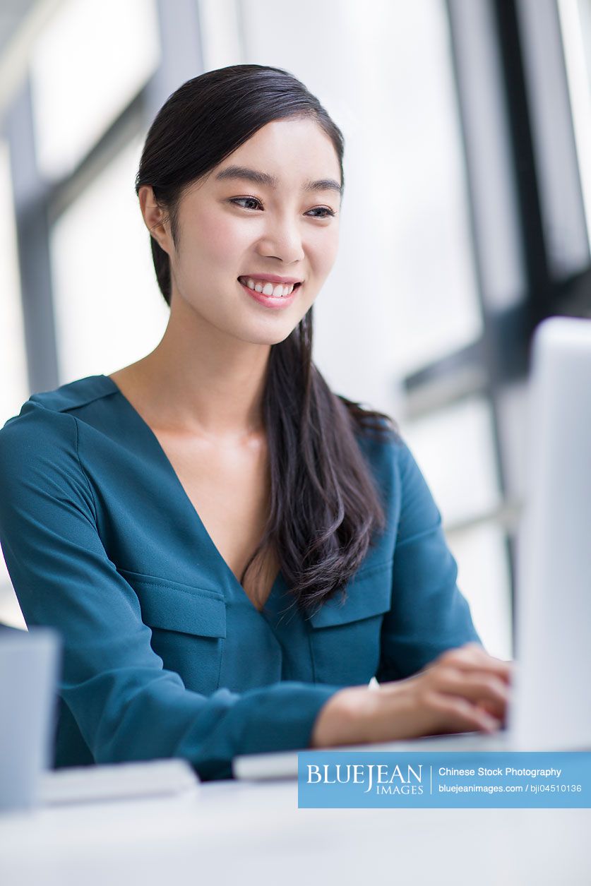 Young Chinese businesswoman working in office