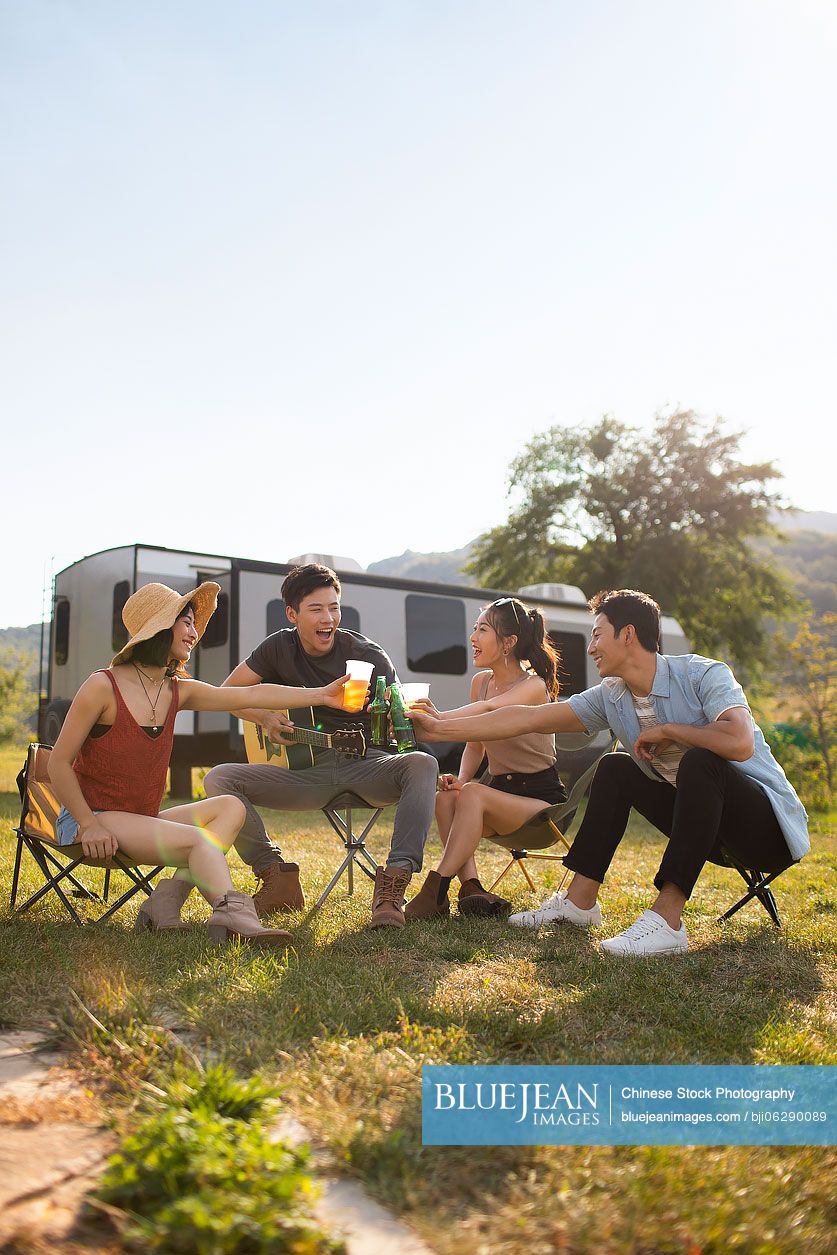 Happy young Chinese friends having fun outdoors