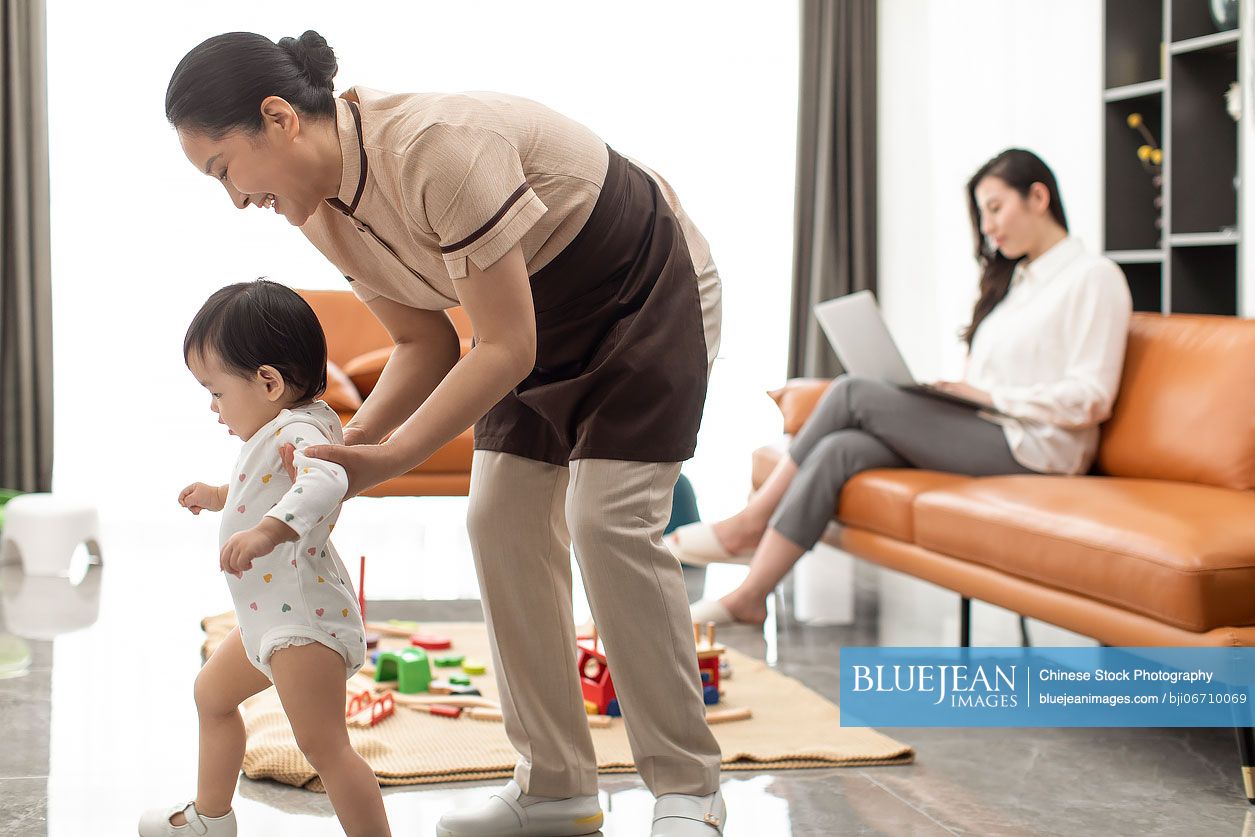 Chinese nanny taking care of baby girl