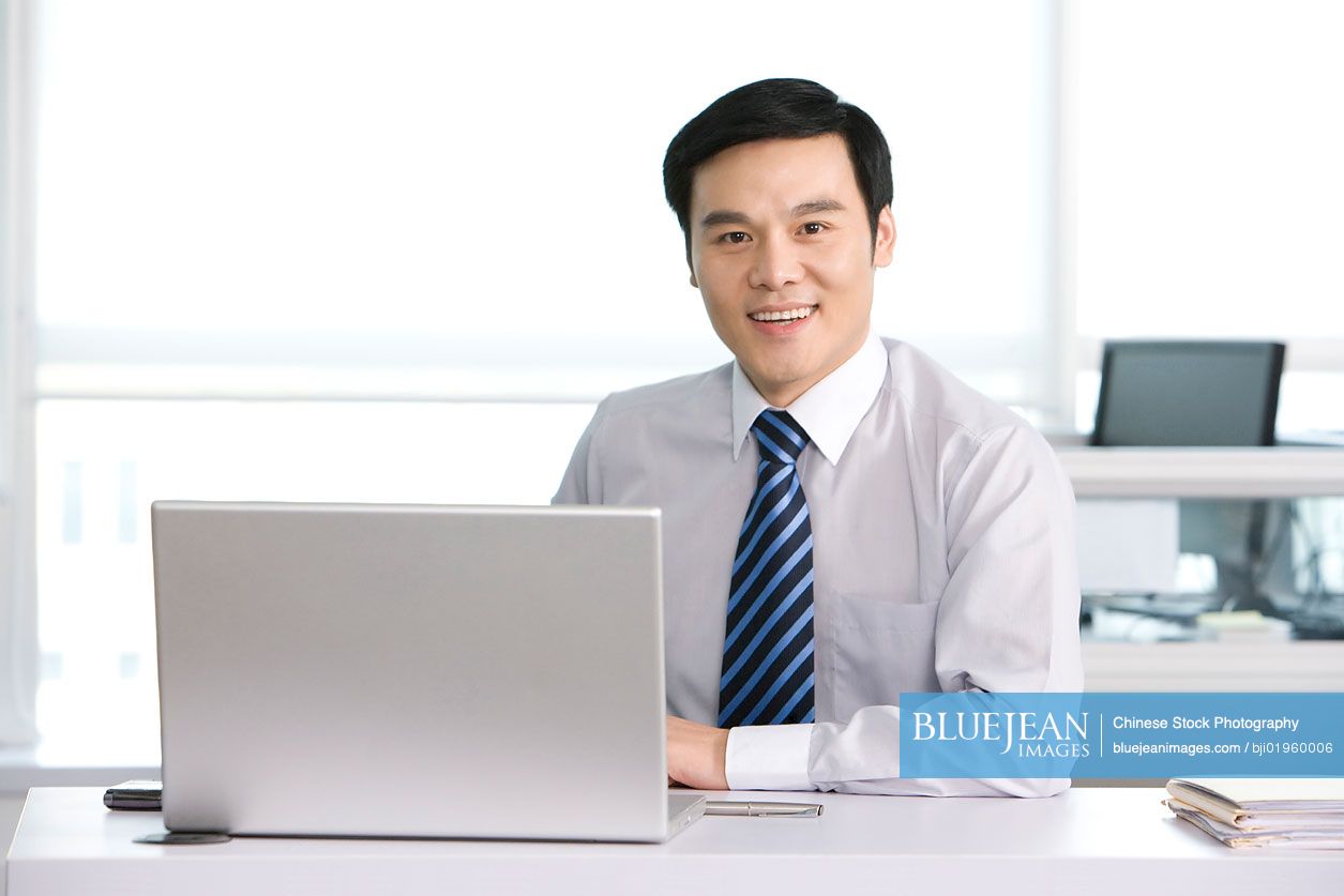 Chinese office worker at his desk